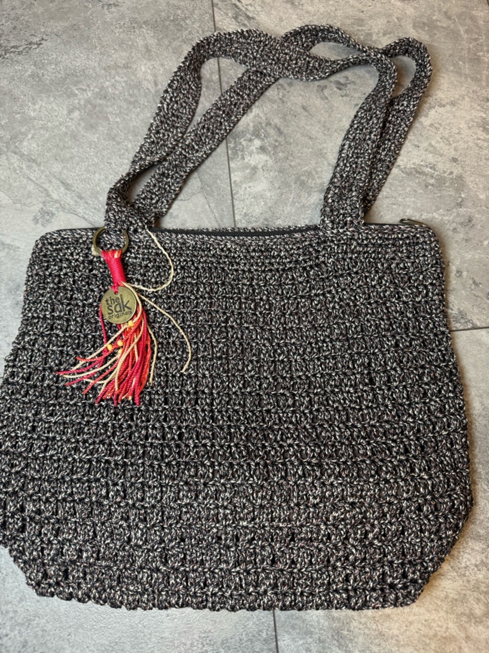 The Sak Black Crochet Tote with Red and Gold Tassel